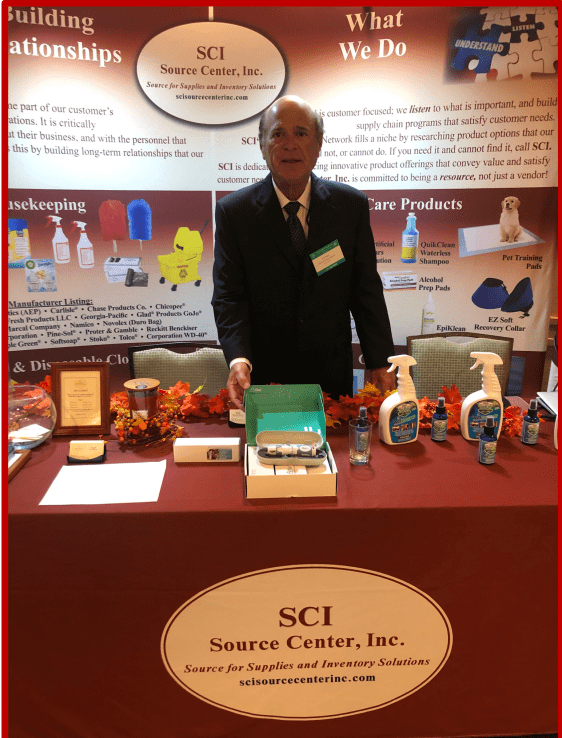 Man presenting various anatomical models at a science center booth.