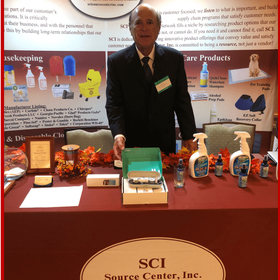 Man presenting various anatomical models at a science center booth.